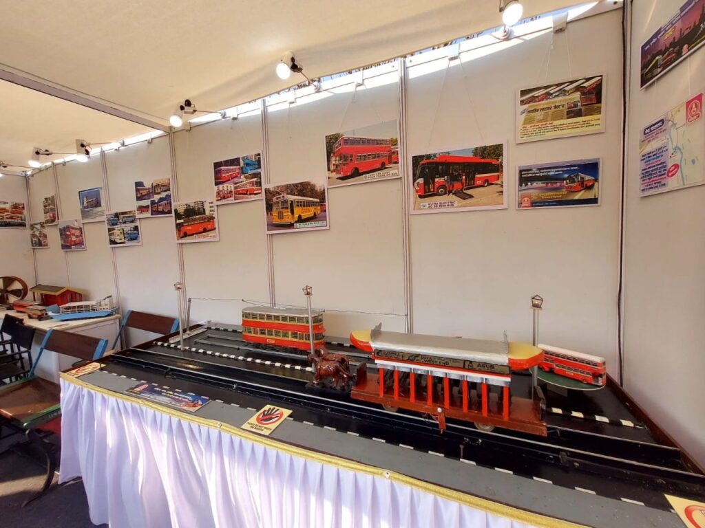 Models of BEST's horse-drawn tram, double decker tram and double decker bus on display.